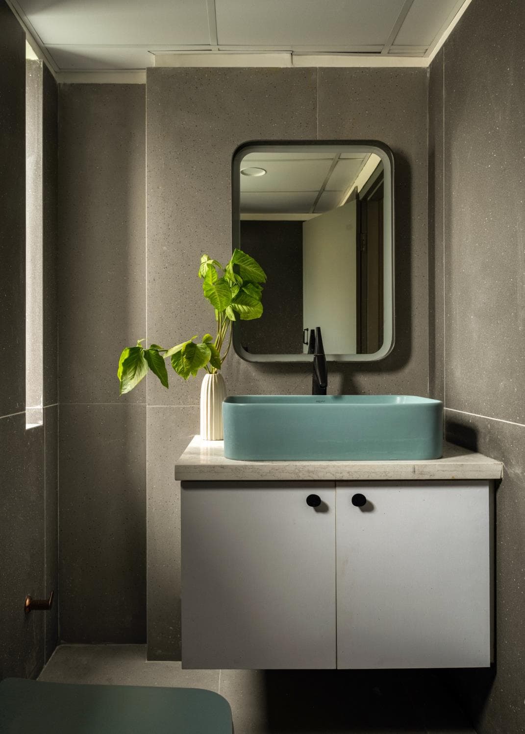 Kids' washroom with colourful tiling and a compact vanity counter