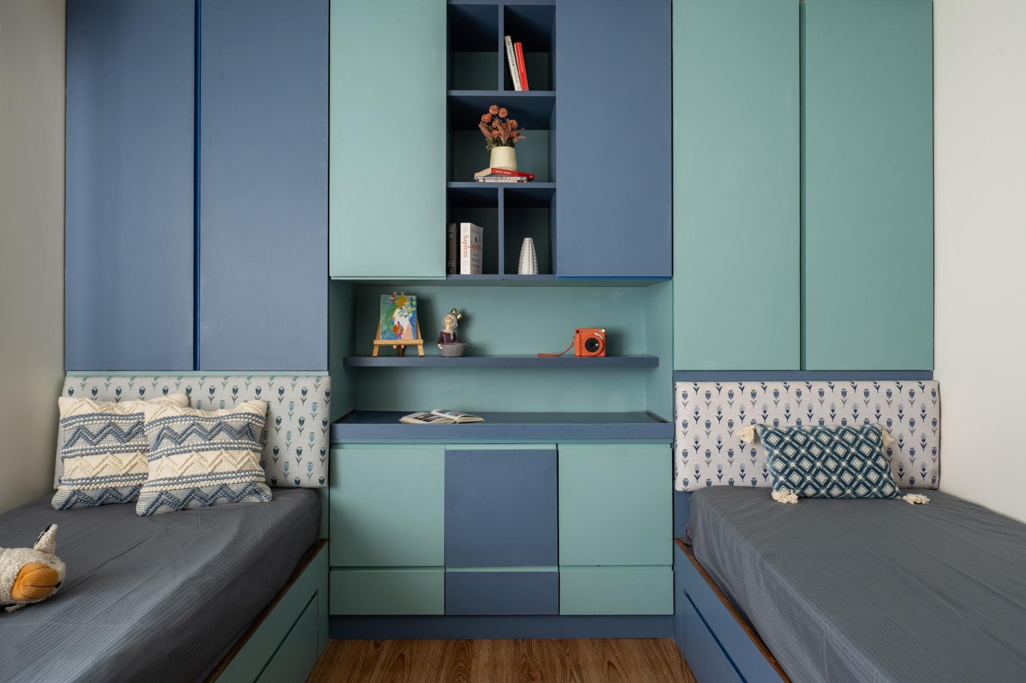 Kids' bedroom with a study desk, bunk-style bed and playful accent colours