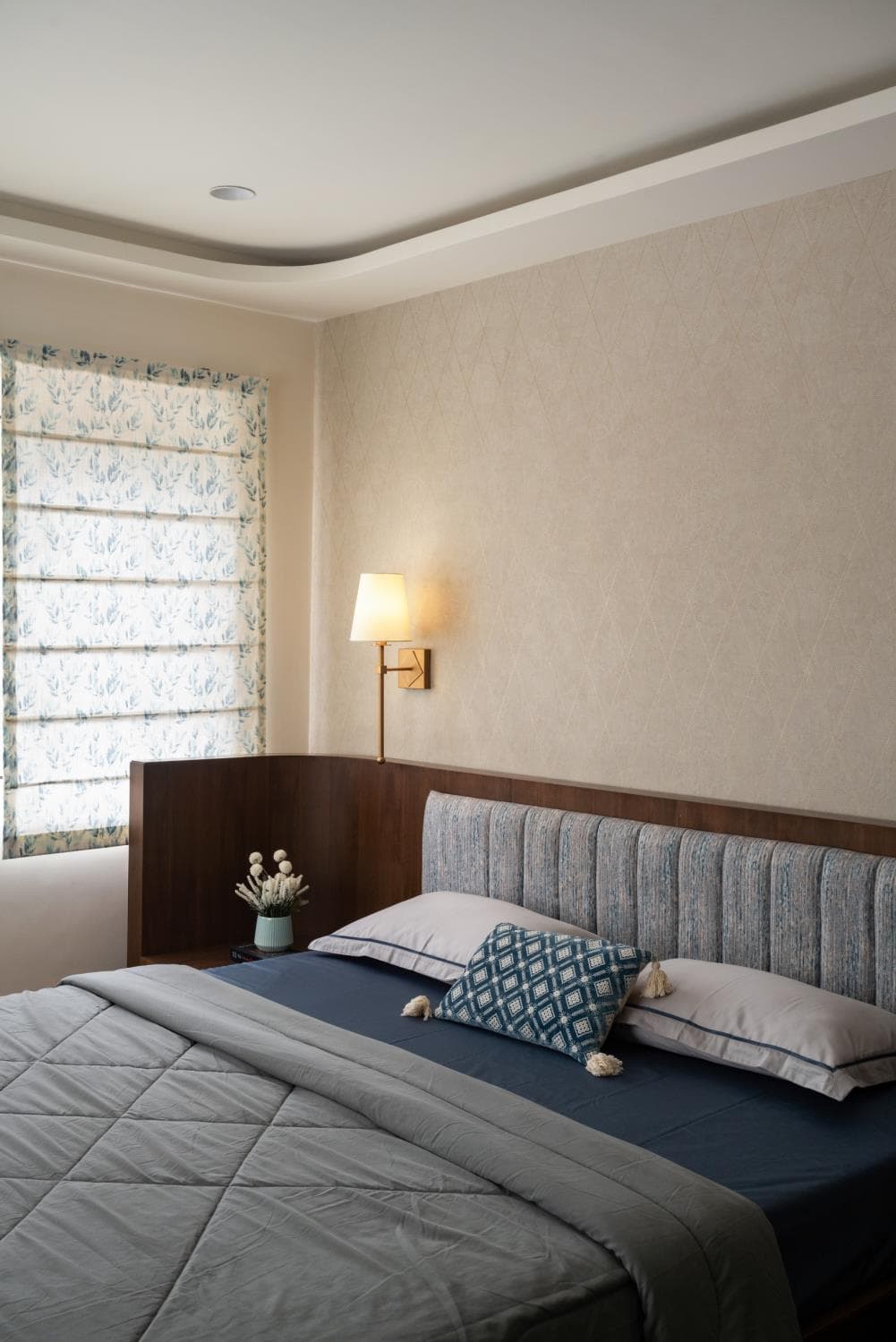Master bedroom seating nook beside a large window with sheer curtains