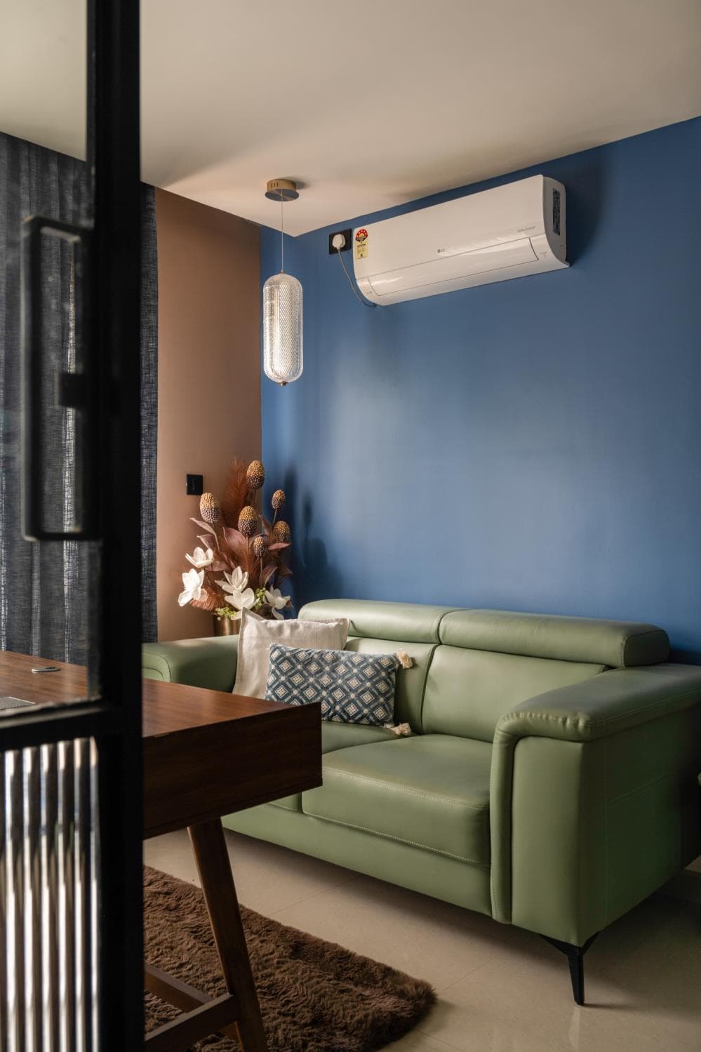 Small home-office lounge corner with an armchair beside a wood-panelled wall