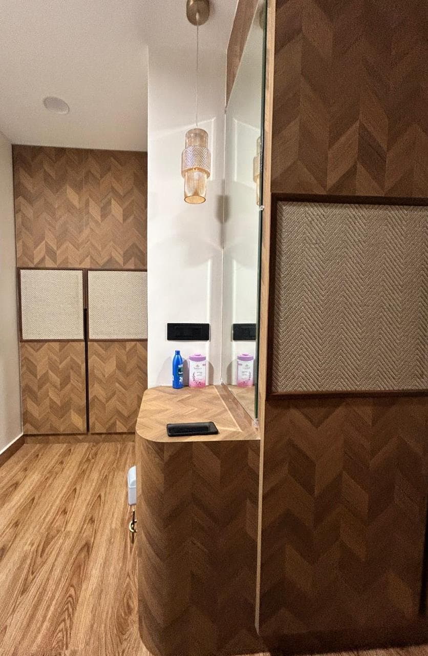 Dresser unit in the parents' bedroom with a mirror and soft accent lighting
