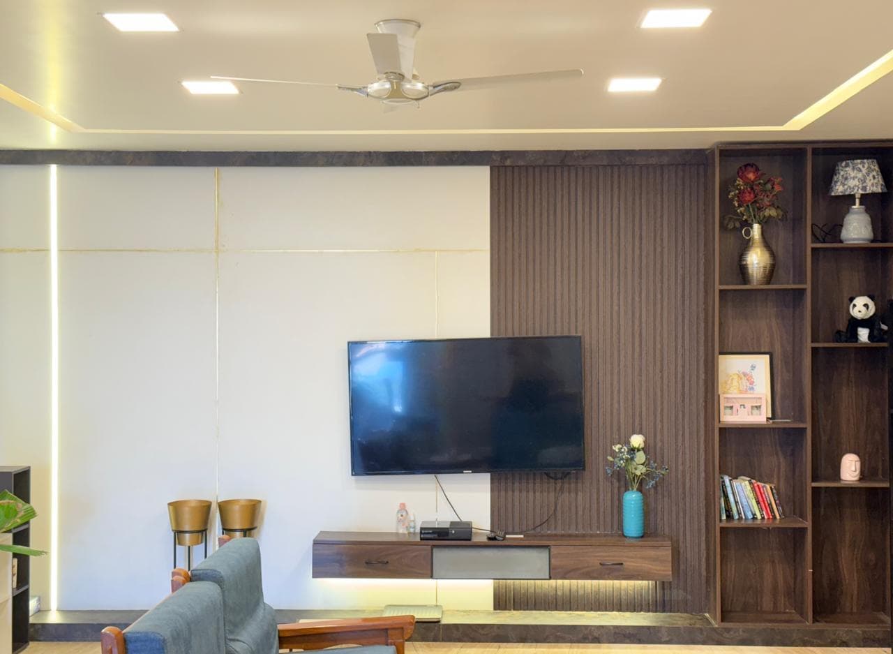 Living room TV unit in warm wood tones with an earthy textured backdrop